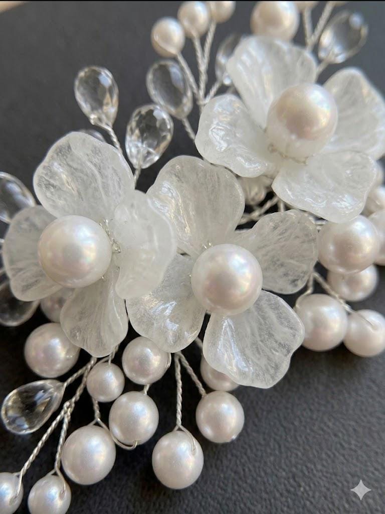 Close-up of white glass petals, pearls and teardrop crystals