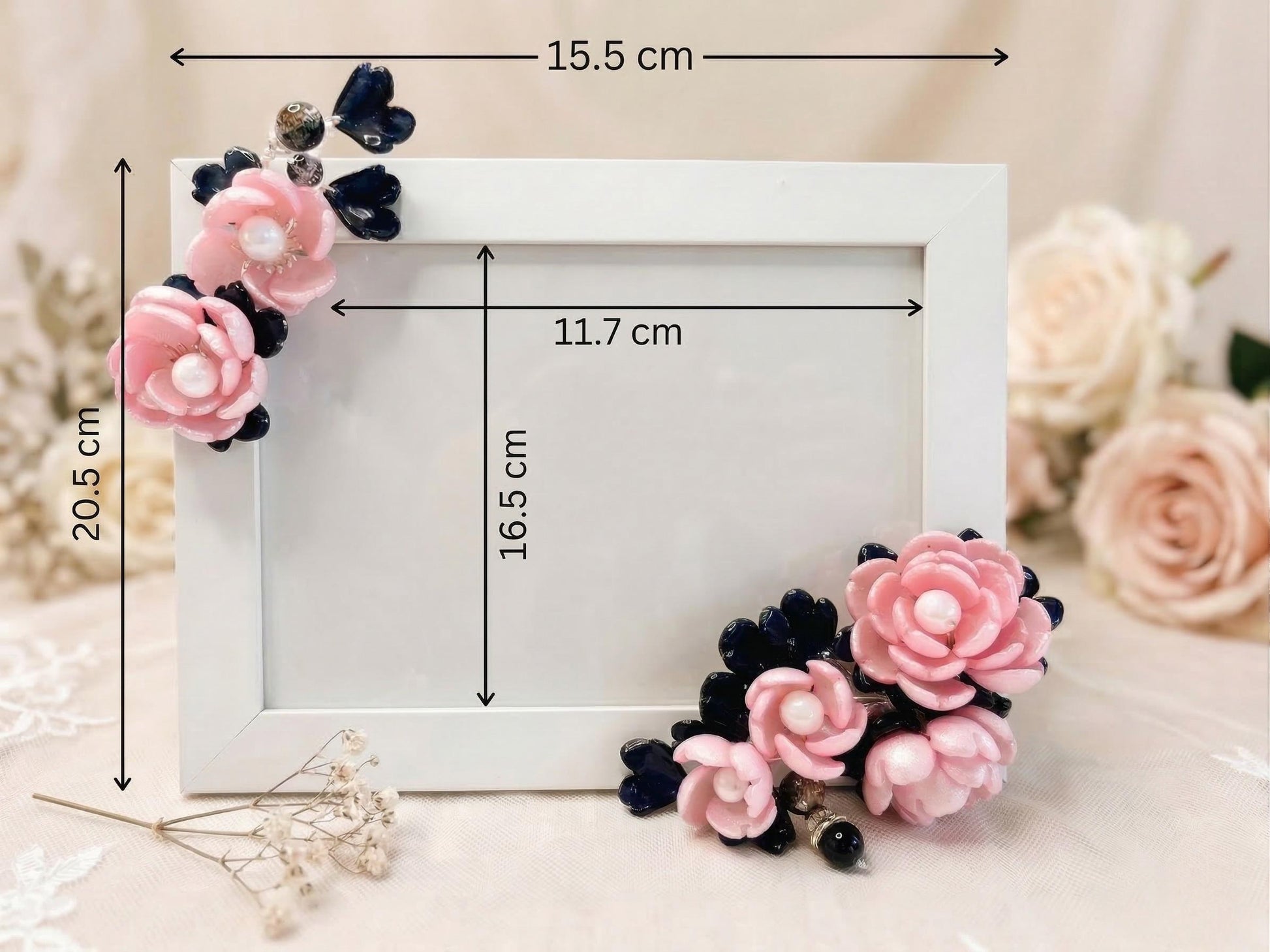 Close-up of pink glass roses with pearl centres and navy petals