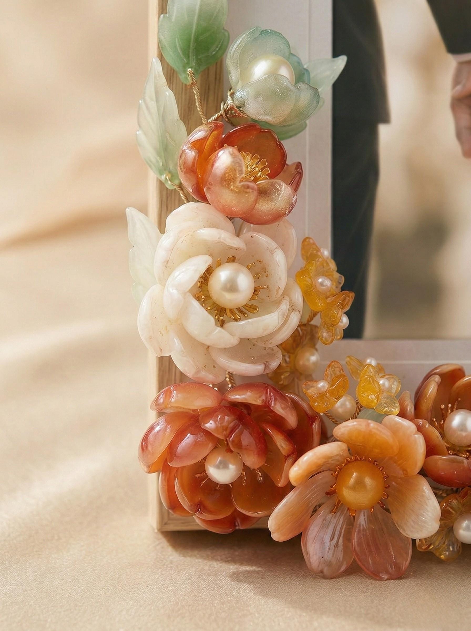 Autumn-toned glass flowers with pearl accents on a wood frame