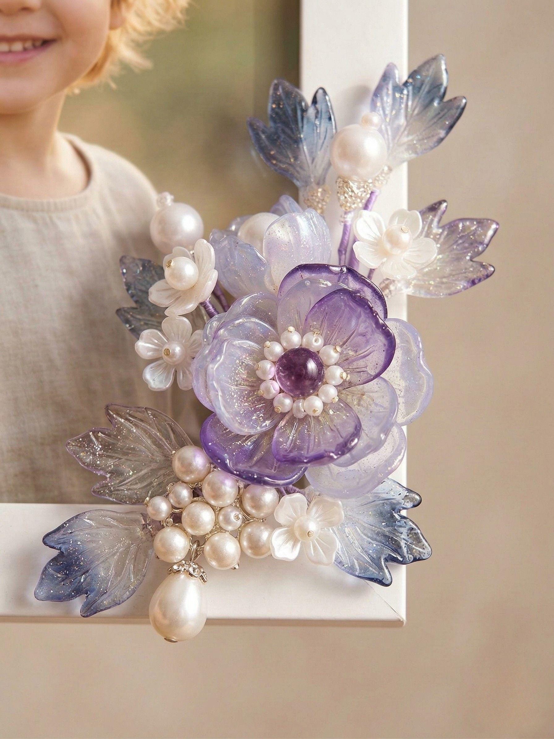 Close-up of purple glass flowers with pearl centre