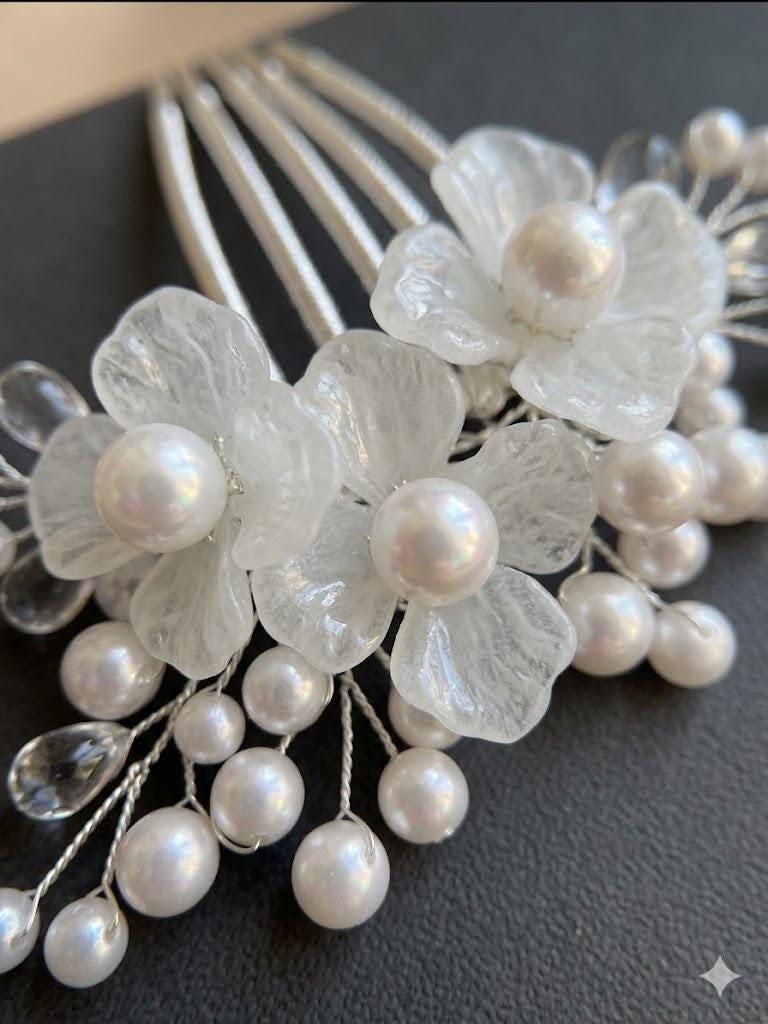 White glass flowers with pearls and crystal accents on a comb