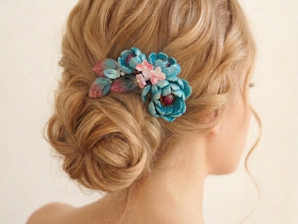 Teal and pink glass floral comb worn in an updo