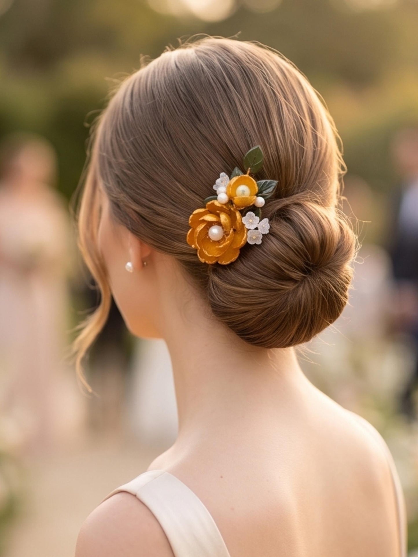 Yellow glass flower hair clip worn at a garden wedding