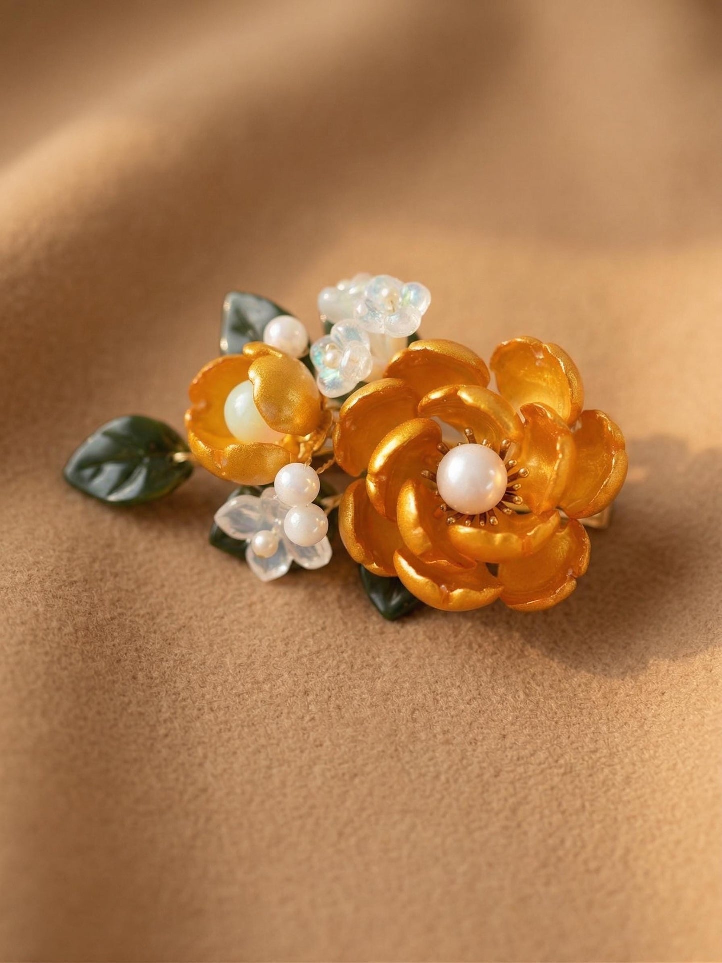 Yellow glass flower clip with white and blue floral accents