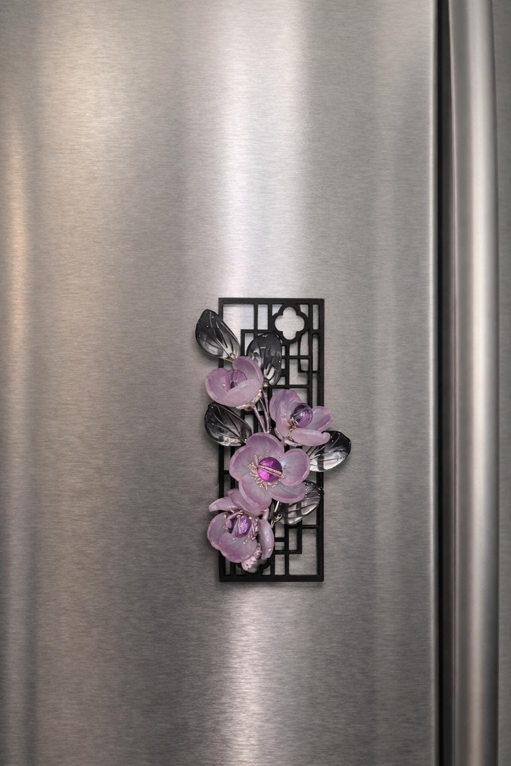 Glass flower magnet held on a stainless steel fridge