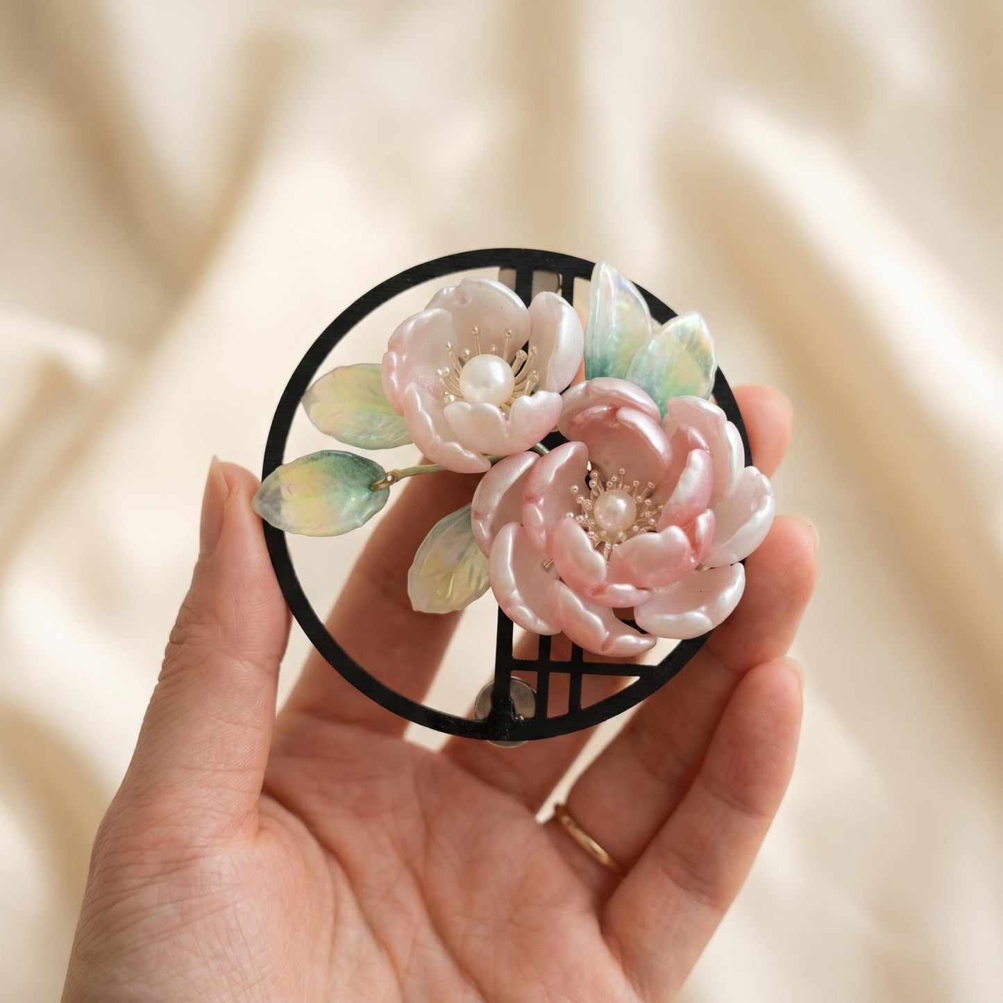 Pink glass peony magnet in a round dark wood frame
