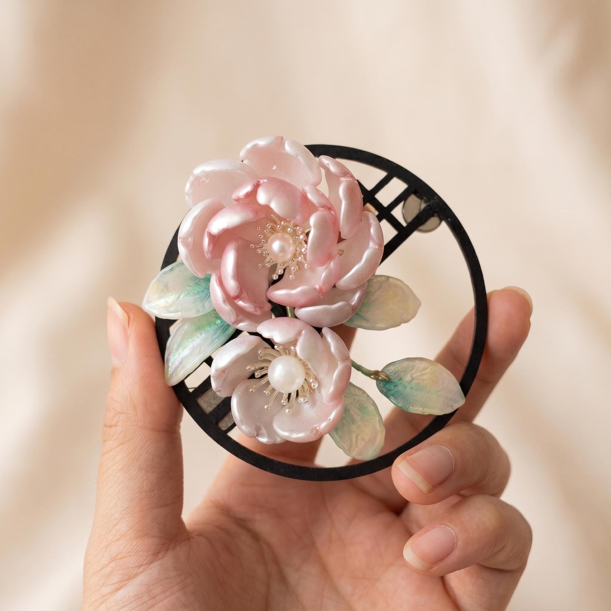 Glass peony magnet held in hand