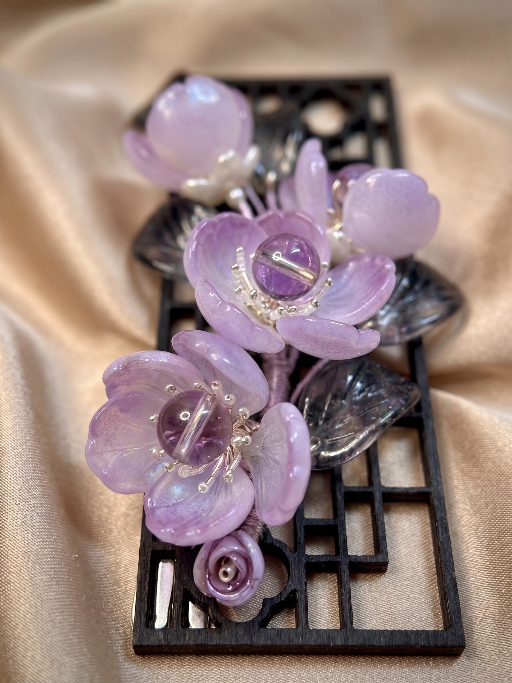 Close-up of lavender glass flowers with crystal centres