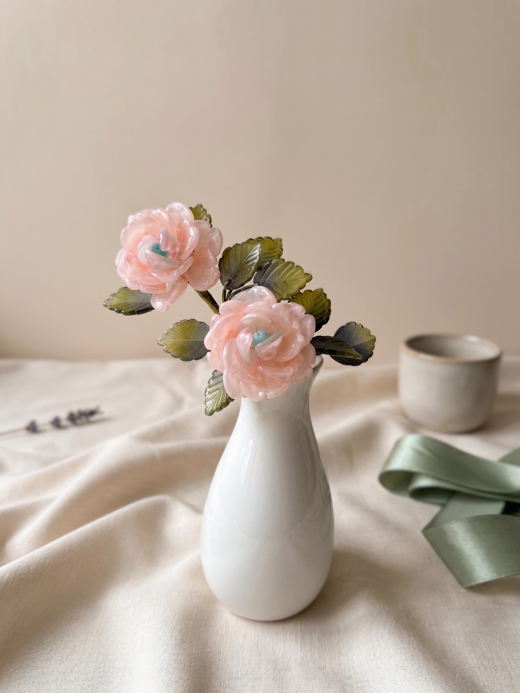 Pink glass rose night light styled on fabric