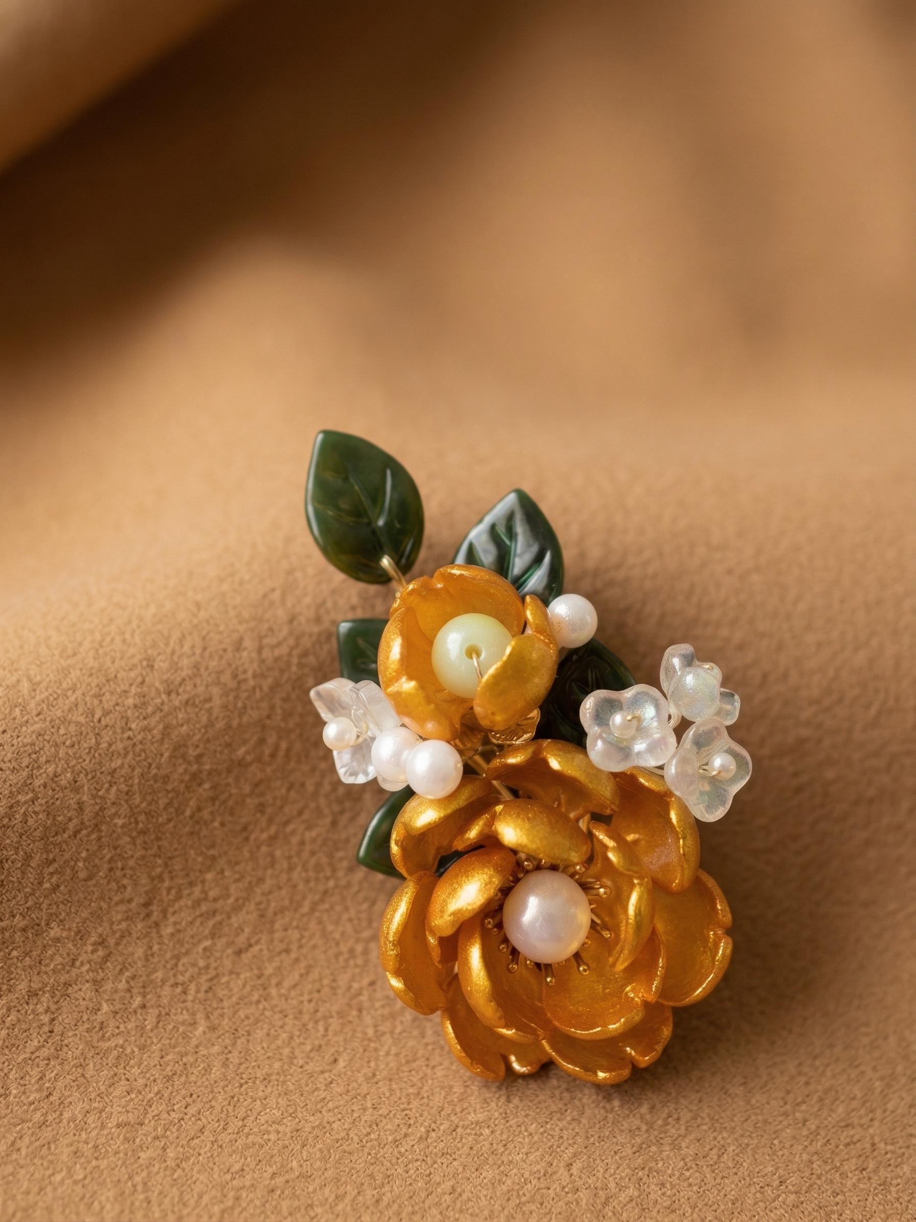 Golden glass flower barrette with green glass leaves