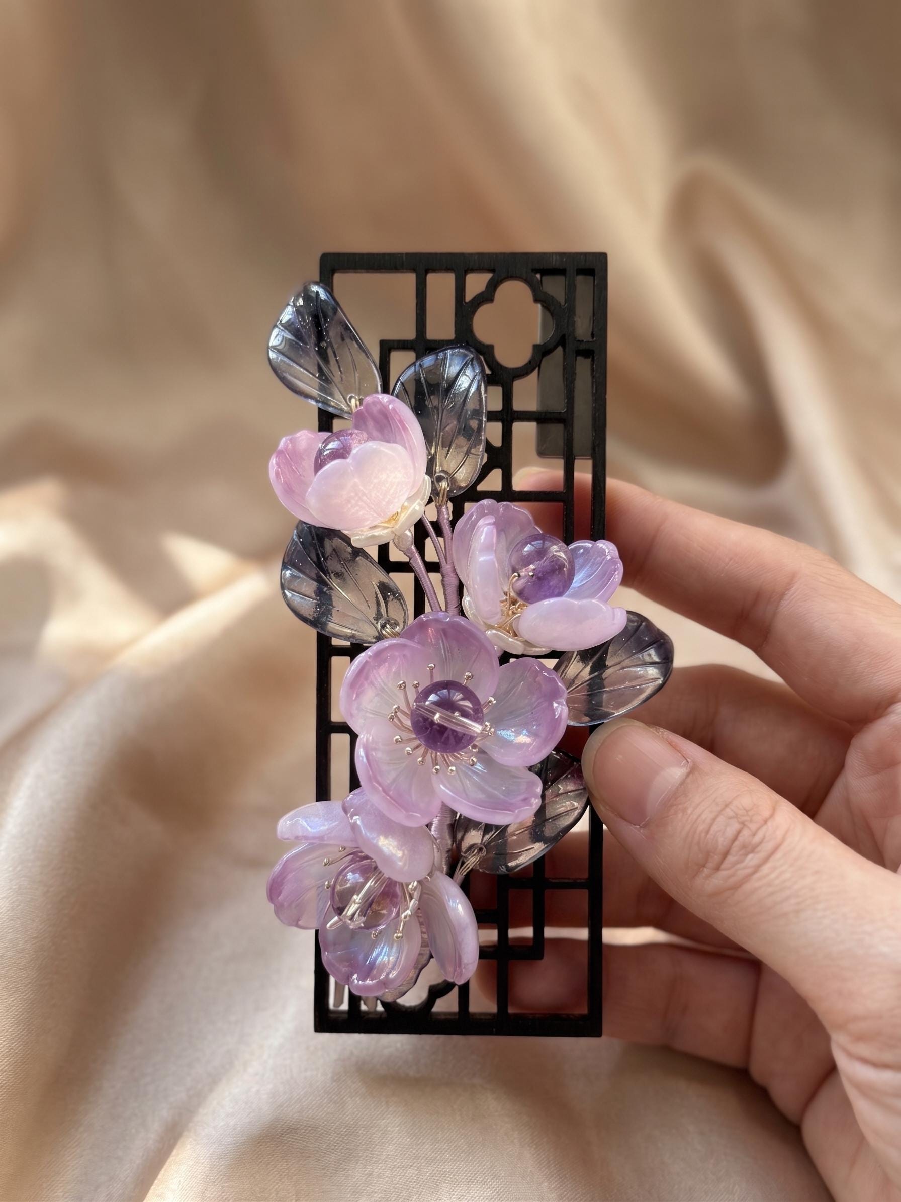 Purple glass flowers on a black openwork frame