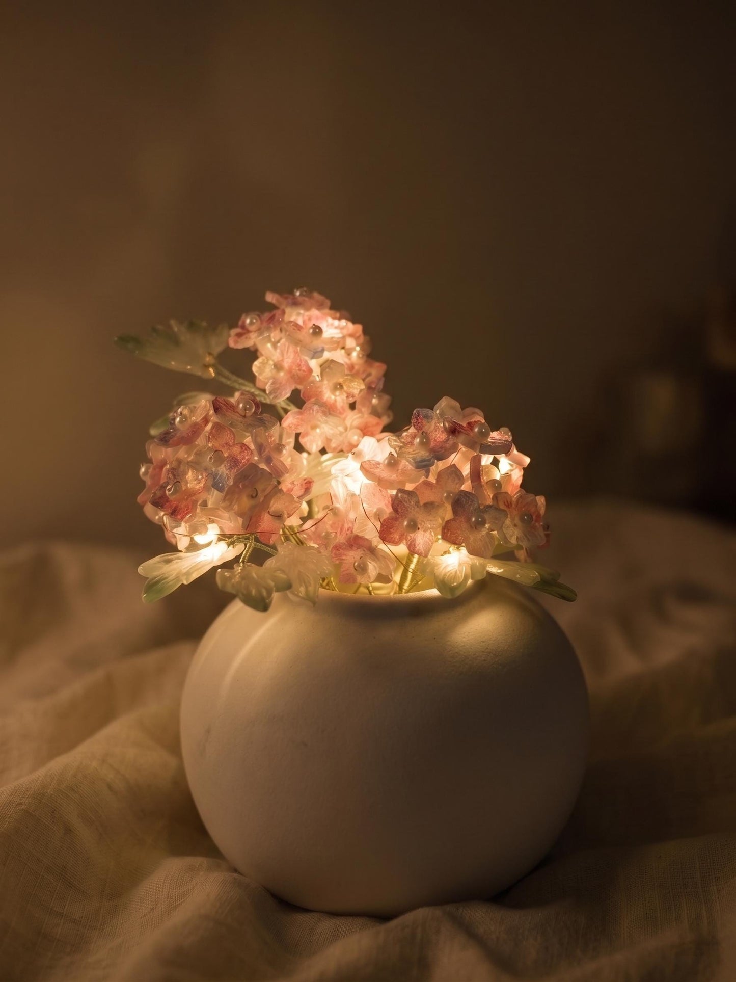 Pink hydrangea glass vase glowing with warm LED lights