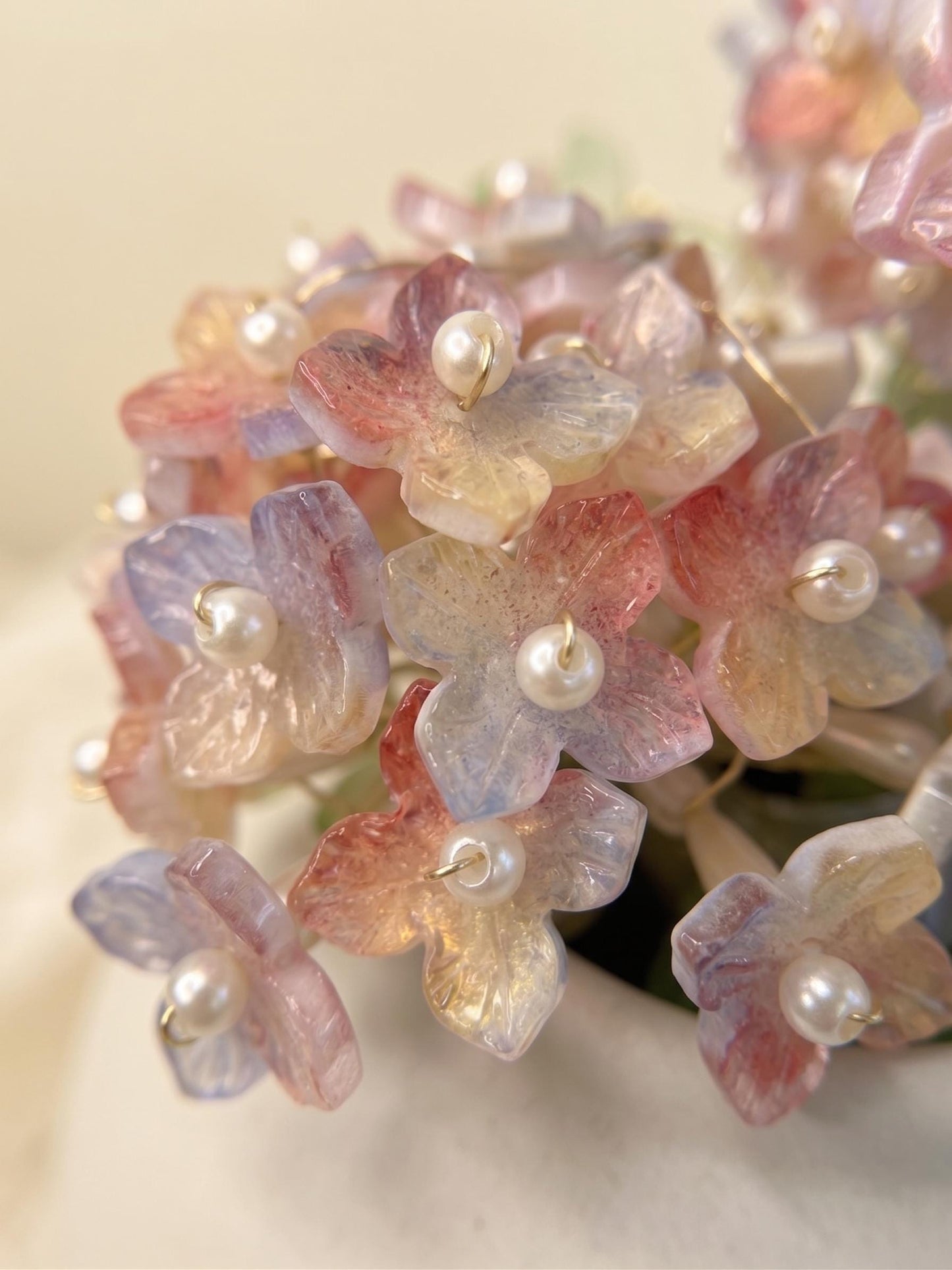 Close-up of translucent glass flowers with pearl centres
