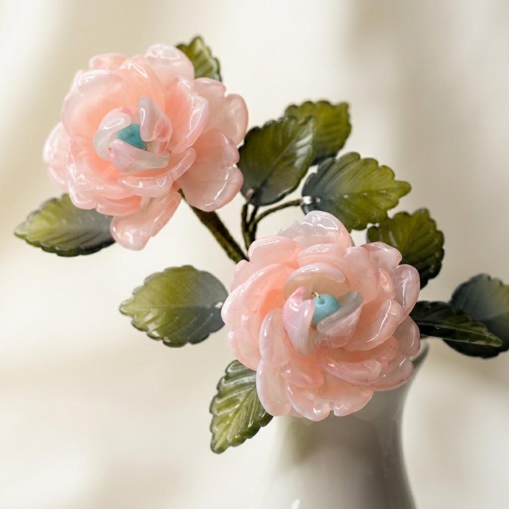 Two pink glass roses with Tiffany-blue centres