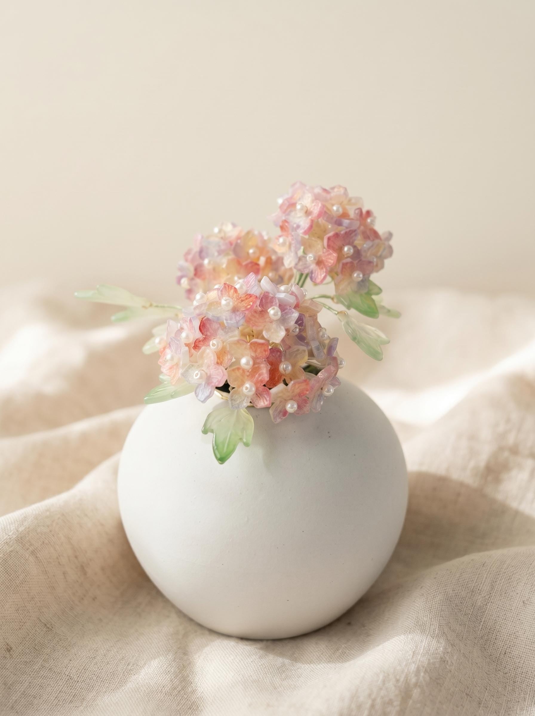Glass hydrangea arrangement with soft pastel colours