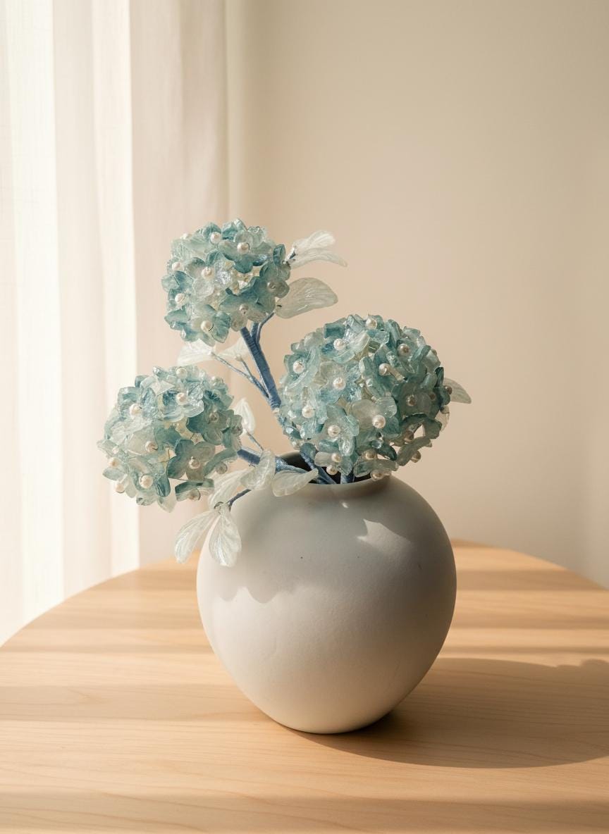 Blue glass hydrangea arrangement with warm LED glow