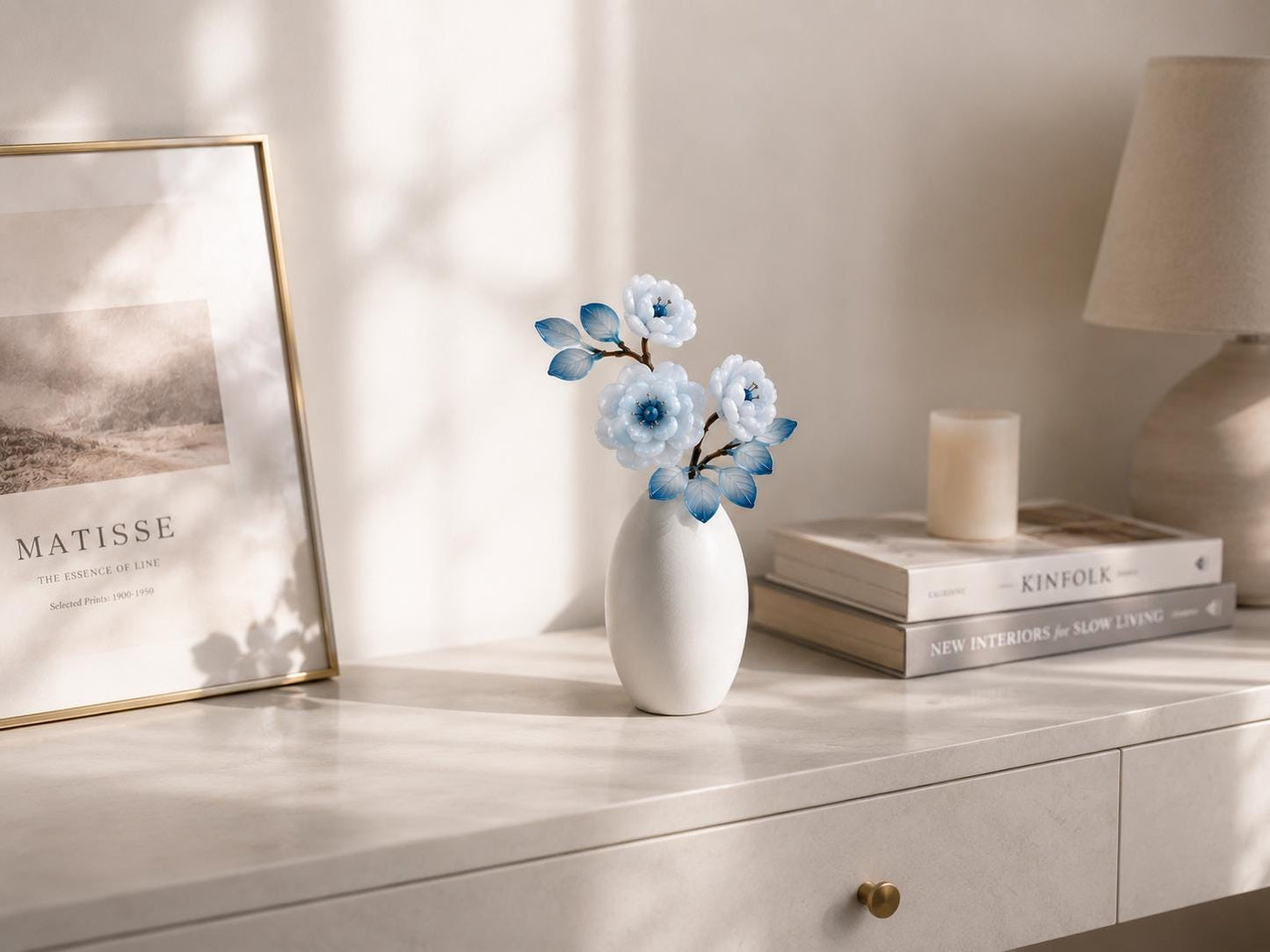 Blue glass flower vase styled on a console