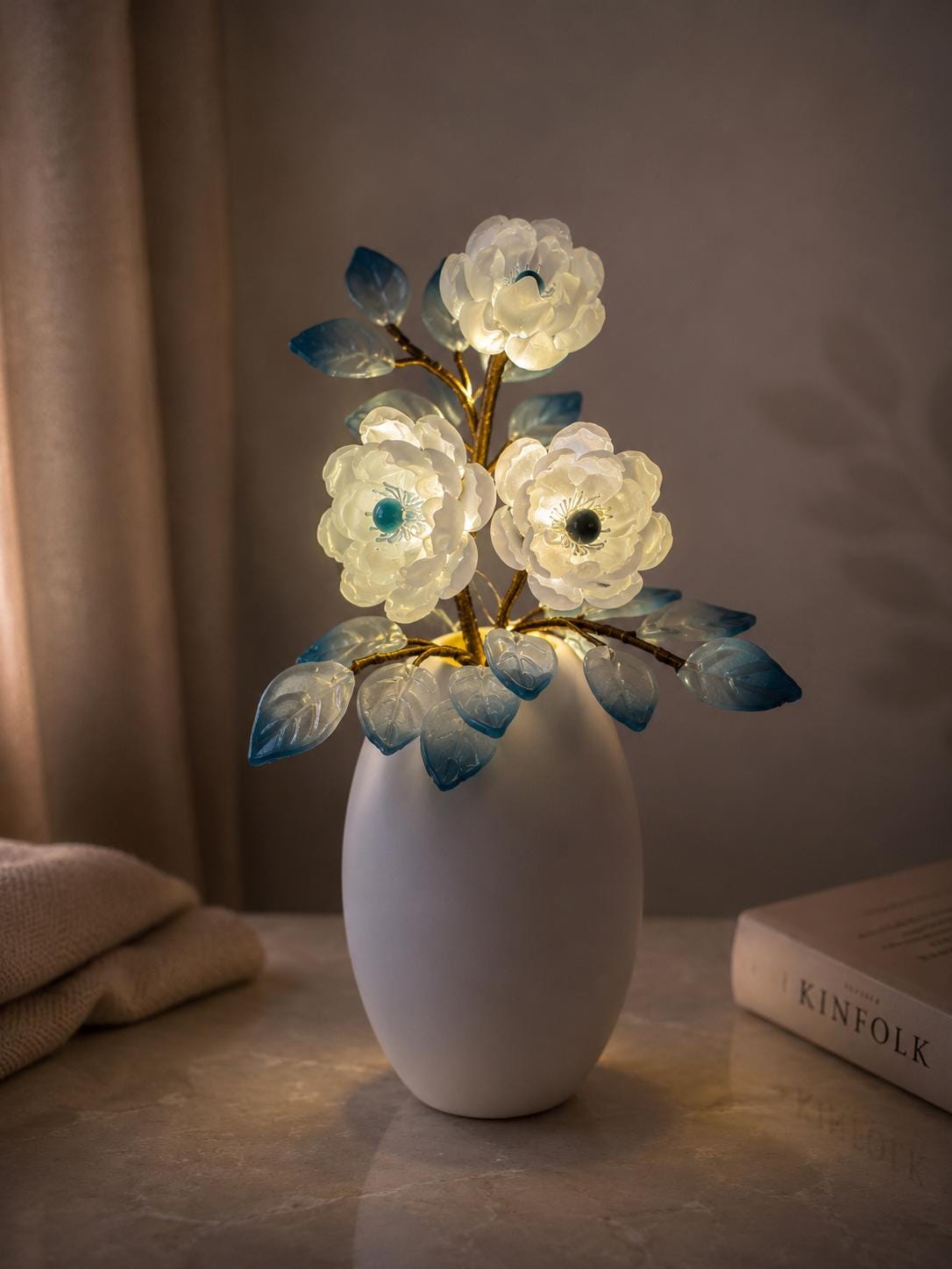 Blue glass flowers glowing softly at night