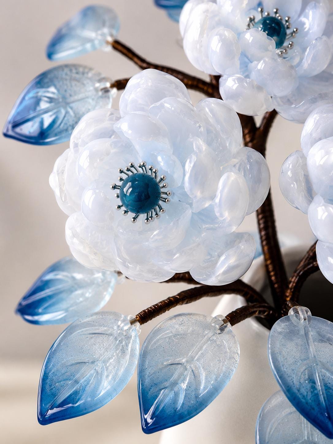 Close-up of a white glass bloom with blue centre