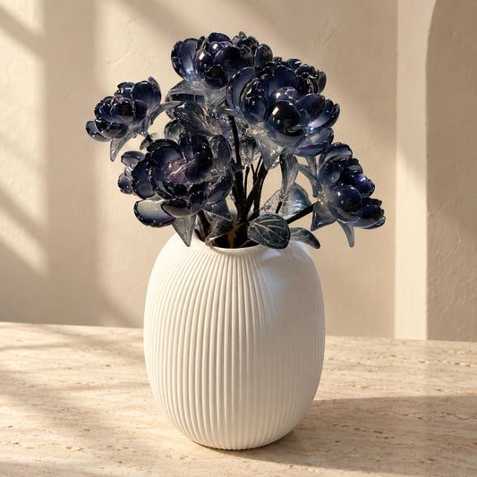 Midnight Bloom black glass flower arrangement in white ribbed ceramic vase