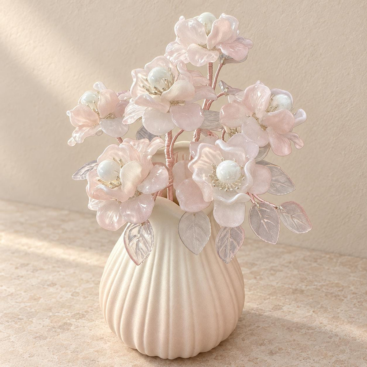 Pink glass camellia arrangement styled on a shelf