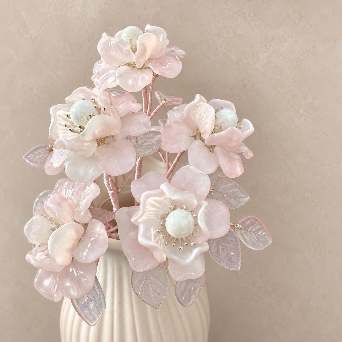 Ribbed pale-pink ceramic vase detail