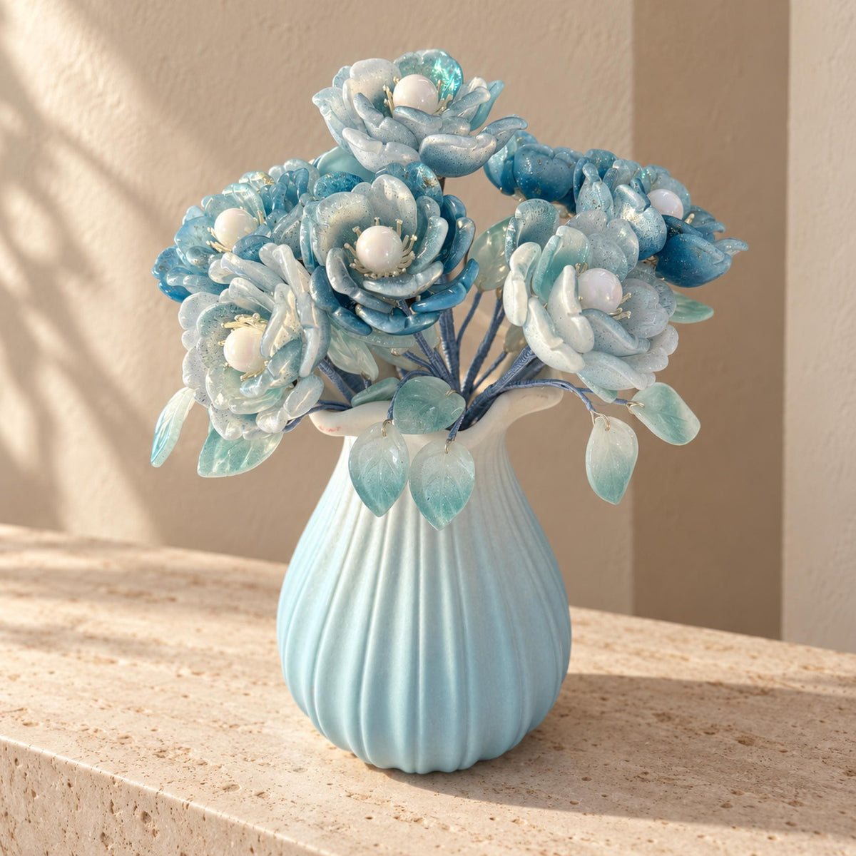 Light blue glass camellia arrangement in ribbed ceramic vase
