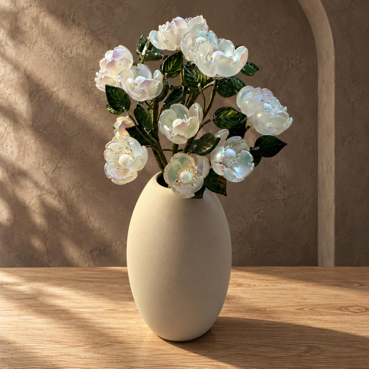 White camellia glass flower arrangement in ceramic vase