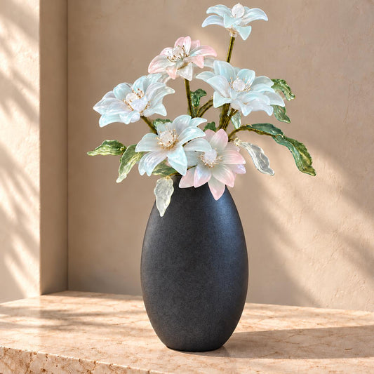Glass lily flower arrangement in ceramic vase
